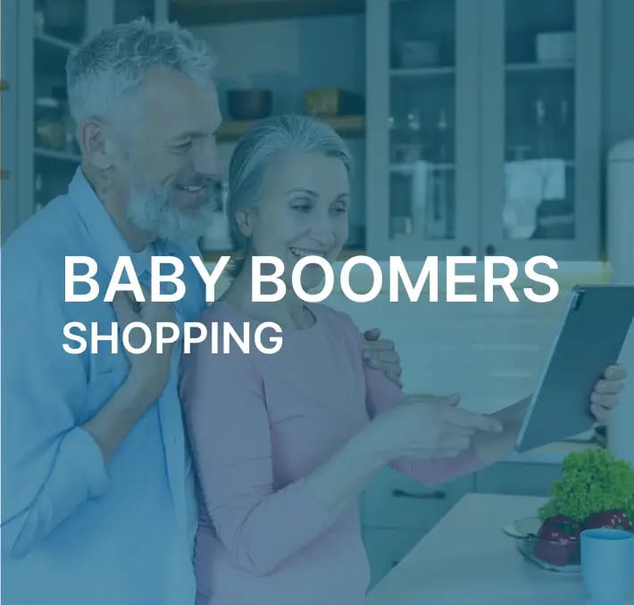 An older man and woman stand in a kitchen, smiling and looking at a tablet together; text over image reads Baby Boomers Shopping.